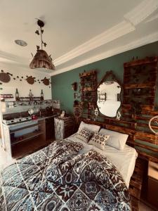 a bedroom with a large bed and a mirror at Cabana House in Dahab