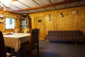 a dining room with a table and a bench at Chalupa Horní Morava in Dolní Morava