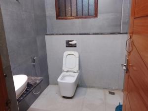 a small bathroom with a toilet and a sink at HoTEL K7 in Chennai