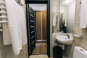 a bathroom with a sink and a mirror at Biдень in Lviv +36 photos
