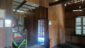 an empty room with a door leading to a living room at Homestay in Kampong Cham in Kampong Cham