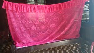 a pink curtain with pink flowers on a window at Homestay in Kampong Cham in Kampong Cham