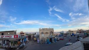 a street in a town with buildings and cars at Cabana House in Dahab