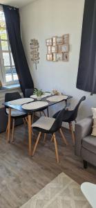 a living room with two tables and a couch at Ostsee No8 Eckernförde in Eckernförde +36 photos