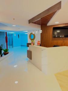 an office lobby with a white counter and a television at Condo Apartment Suite Misti Volcano View in Arequipa