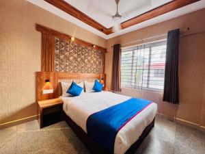 a bedroom with a large bed and a window at Celestial Heights Kakkanad in Cochin
