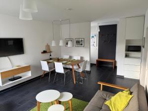 a living room with a table and a couch at Haus Karla in Langeoog +15 photos