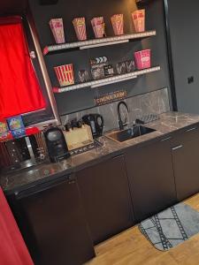 a kitchen with a sink and a counter top at Appartement thème cinéma in Cazouls-lès-Béziers