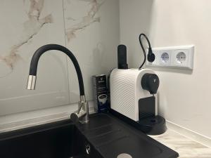 a kitchen counter with a sink and a microwave at Noble Rooms Saarbrücken in Saarbrücken +41 photos