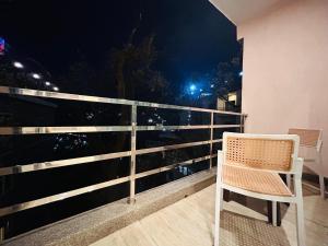 a chair sitting on a balcony at night at The Oakleaf Retreat - A Near Mall Road With Parking in Mussoorie