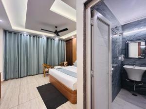 a bedroom with a bed and a bathroom with a sink at The Oakleaf Retreat - A Near Mall Road With Parking in Mussoorie +55 photos