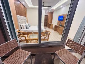 a view of a room with a bed and a living room at The Oakleaf Retreat - A Near Mall Road With Parking in Mussoorie