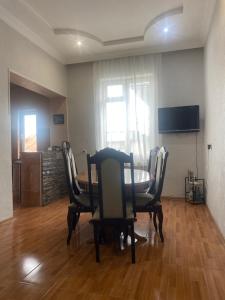 a dining room with a table and chairs and a television at Sisi Guest House in Kutaisi +17 photos