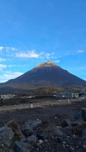 a mountain in the middle of a field with rocks at Funco Vulcao in Cova Figueira