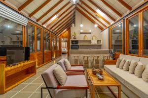 a living room with a couch and a tv at Casa Tartaruga in Unawatuna