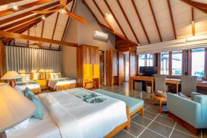 a bedroom with a bed and a living room at Casa Tartaruga in Unawatuna