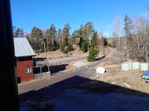a view of a farm with a red barn and a road at Borgahallen The Wedding Room in Rimbo