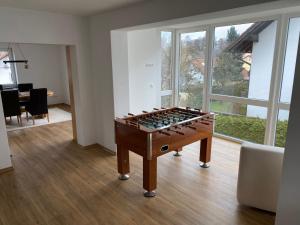 a living room with a foosball table in the middle at Ferienwohnung unterm Äpflet in Furth im Wald