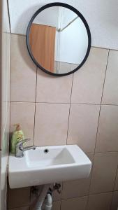 a bathroom with a sink and a mirror on the wall at GREEN MOON Breza in Breza