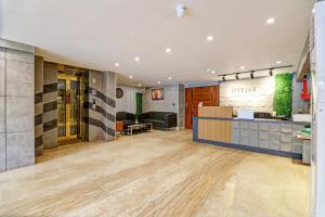 a lobby of a store with a waiting area and a counter at Hotel City inn in New Delhi