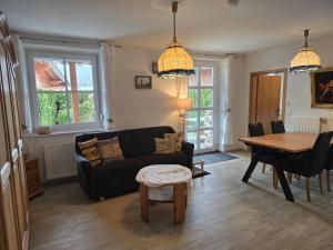a living room with a couch and a table at Ferienwohnung Christine in Bischofswiesen