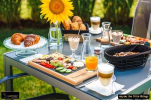 a table with a tray of food and a sunflower at Vitalpension Bad Blumau - ADULTS ONLY in Bad Blumau