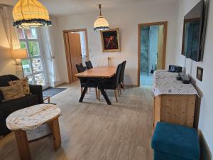 a living room with a table and a dining room at Ferienwohnung Christine in Bischofswiesen +15 photos