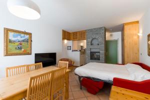 a bedroom with a bed and a table and a fireplace at Residenza Del Sole in Gressoney-Saint-Jean