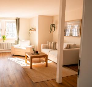 a living room with a couch and a table at Restaurant & Pension Skipper Zingst in Zingst