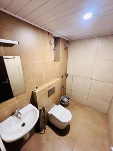 a bathroom with a white toilet and a sink at Celestial Heights Kakkanad in Cochin