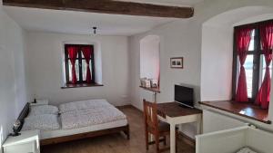 a bedroom with a bed and a desk with a computer at HabaChalupa in Šumperk