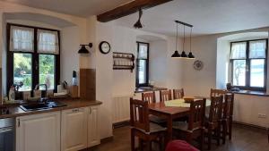 a kitchen and dining room with a table and chairs at HabaChalupa in Šumperk