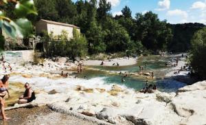 a group of people swimming in a river at Le Cocon du Ventoux Studio cosy à Carpentras in Carpentras