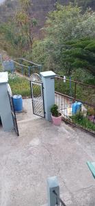 a gate with a potted plant next to a fence at Sandeep Homes in Tehri-Garhwāl