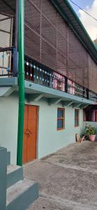 a building with a balcony and a building at Sandeep Homes in Tehri-Garhwāl