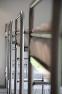 a row of metal bunk beds in a room at Casa Carmina Hostel in Muros de Nalón