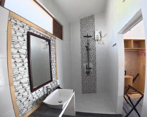 a bathroom with a sink and a shower with a mirror at Adroit Sunset View in Guraidhoo +152 photos