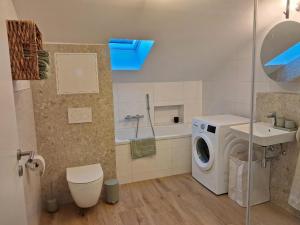 a bathroom with a washing machine and a sink at Apartment Romi in Bad Waldsee
