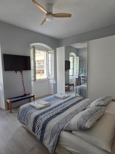 a bedroom with a large bed with a ceiling fan at B&B Dal Nonno in Riva del Garda