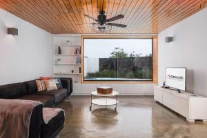a living room with a couch and a large window at TableTop by Azorean Living in Ponta Delgada