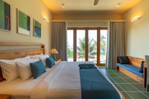 a bedroom with a large bed and a couch at Casa Tartaruga in Unawatuna +56 photos