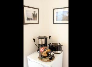 a coffee maker sitting on top of a white cabinet at Le Petit Marigny in Marigny-lʼÉglise