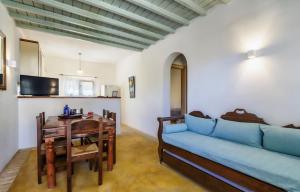 a living room with a blue couch and a table at Bella Alba in Kalafatis