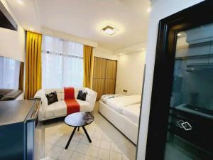 a hotel room with a bed and a couch at Lanson in Nairobi