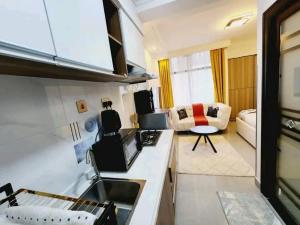 a kitchen and living room with a couch in a room at Lanson in Nairobi