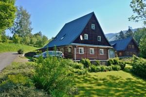 a large wooden house with a black roof at Chalupa Horní Morava in Dolní Morava
