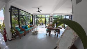 a living room with a couch and a table at Adroit Sunset View in Guraidhoo