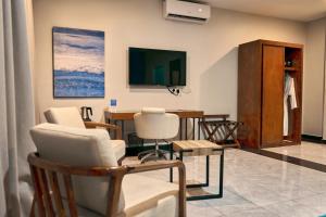 a living room with a table and chairs at Lifestyle Boutique Hotel in Lilongwe