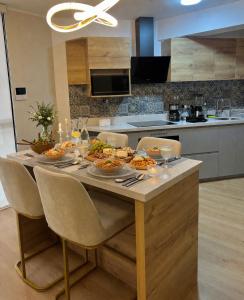 a table with plates of food on it in a kitchen at Condo Apartment Suite Misti Volcano View in Arequipa