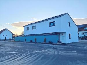 a white building on the side of a street at Apartment Romi in Bad Waldsee